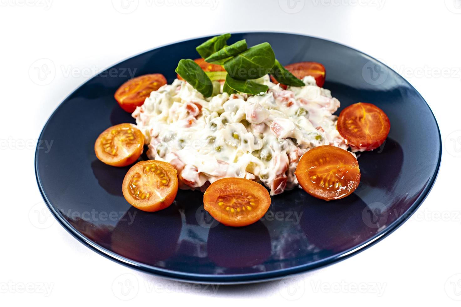 Russian salad on blue plate photo