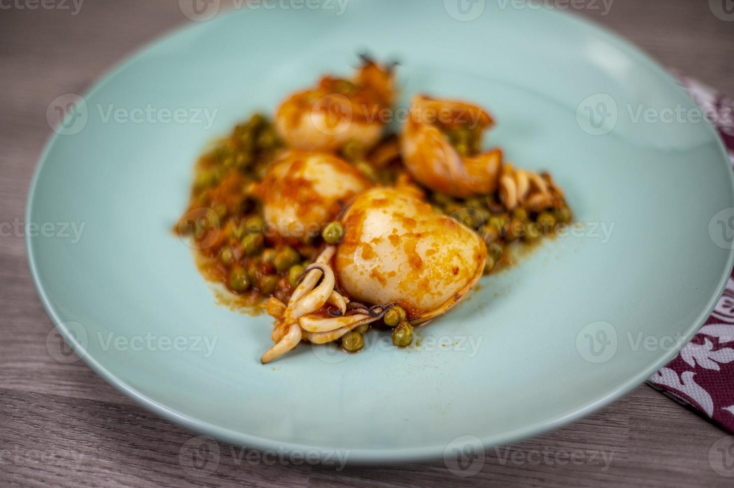 second course with cuttlefish and peas photo