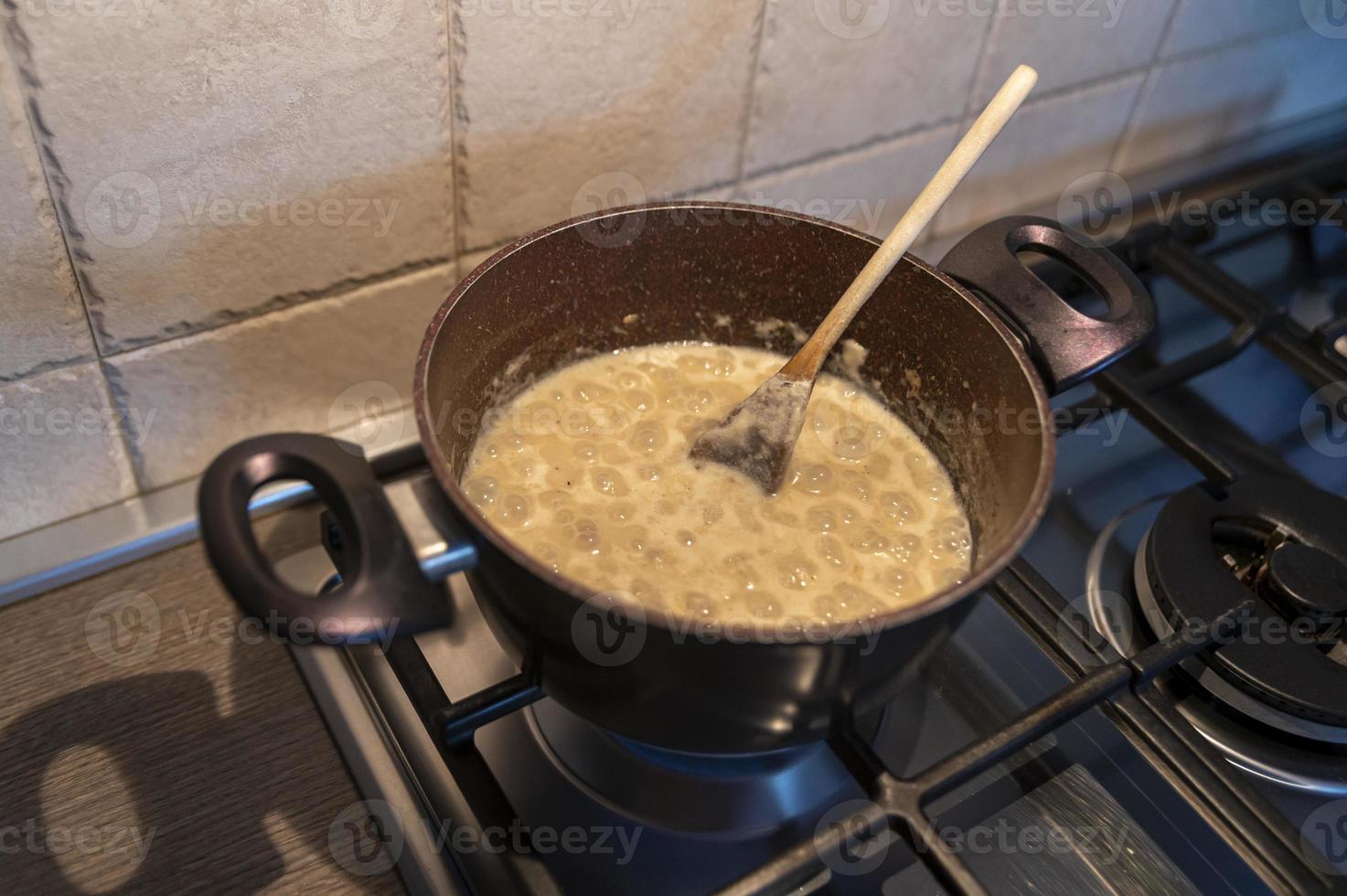 risotto with truffle boiling in a pot photo