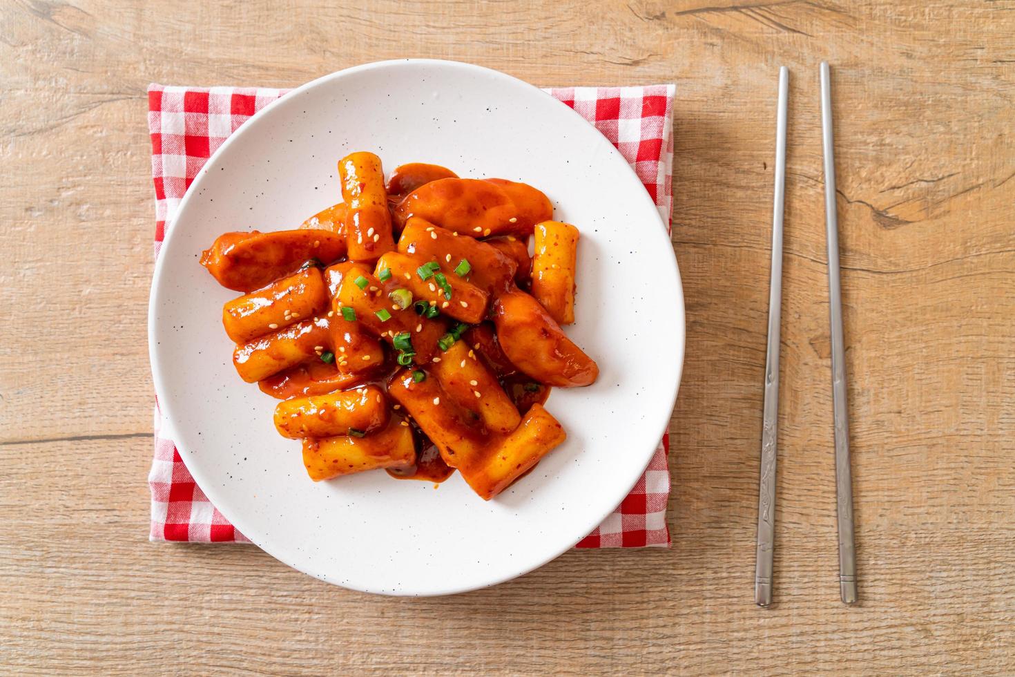 Korean rice cake stick with sausage in spicy sauce - Tteokbokki photo