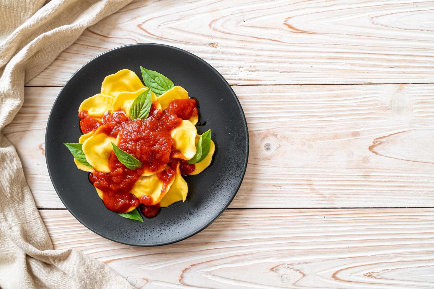 Ravioli with tomato sauce and basil photo
