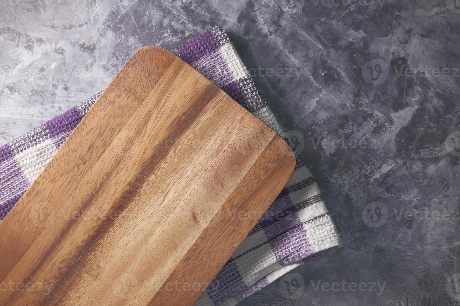 Wooden chopping board on table top down photo