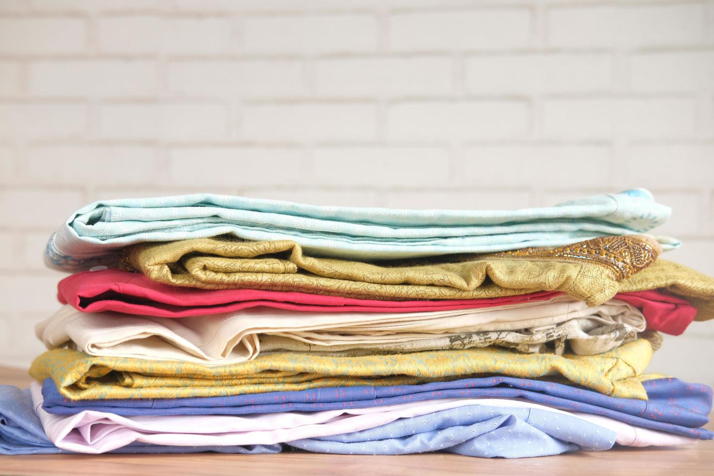 Close up of stack of clothes on table photo