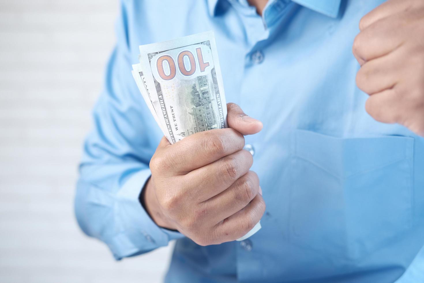 Close up of man hand counting 100 us dollar cash photo