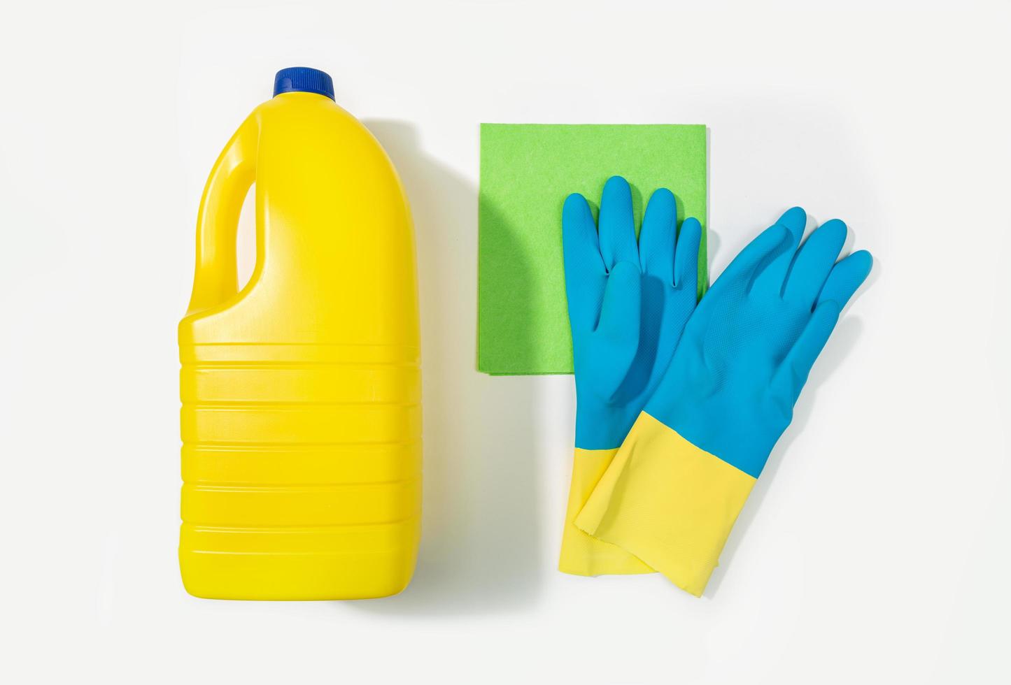 Bleach bottle, protective gloves and rag. Cleaning concept. Top view photo