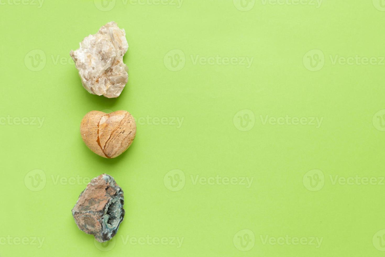 Backgrounds and textures, nature concept - rocks and minerals. Different minerals and heart stone on green background. photo