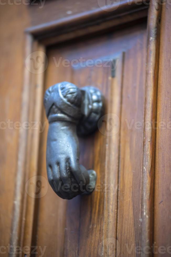 knocker in the shape of a knocking hand photo