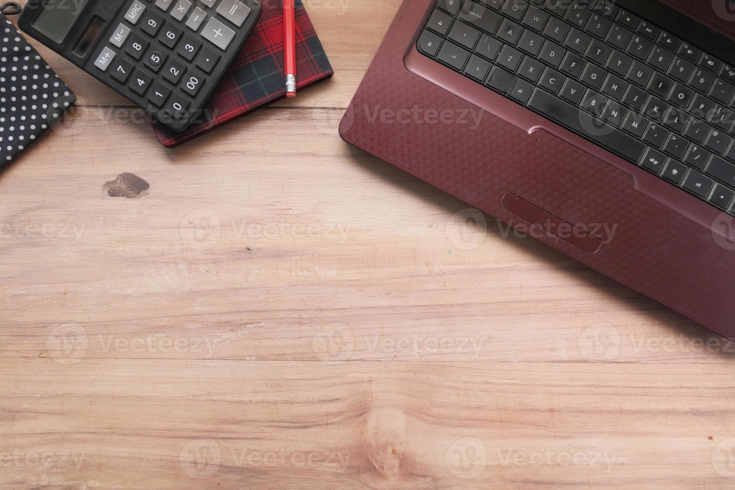 Flat composition of laptop and office stationary on wood desk photo