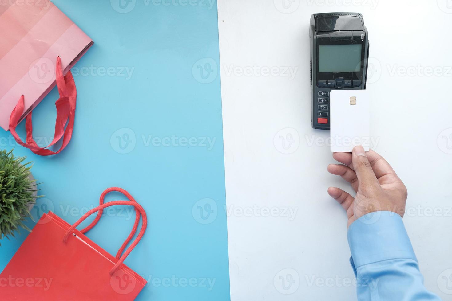 Contactless payment concept with young man paying with credit card photo