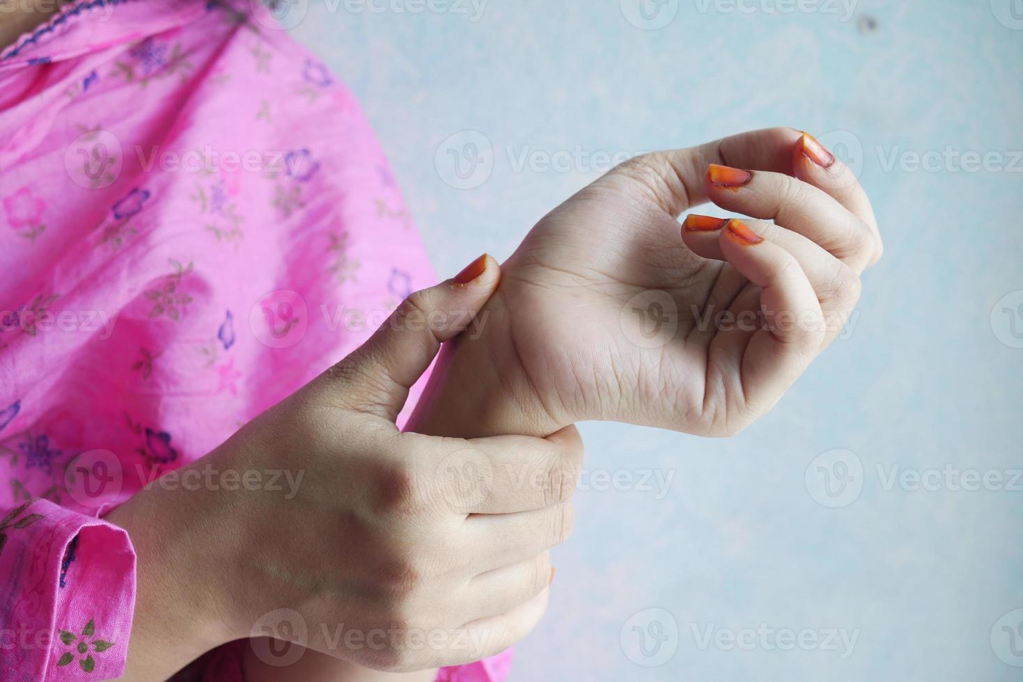 Young women hands suffering wrist pain, photo