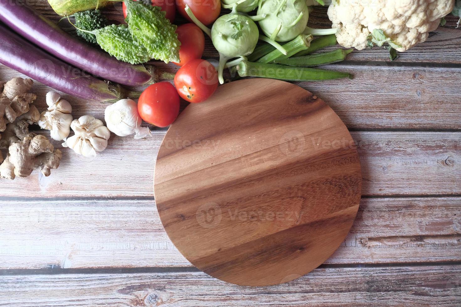 Healthy food selection with fresh vegetables on chopping board on table photo