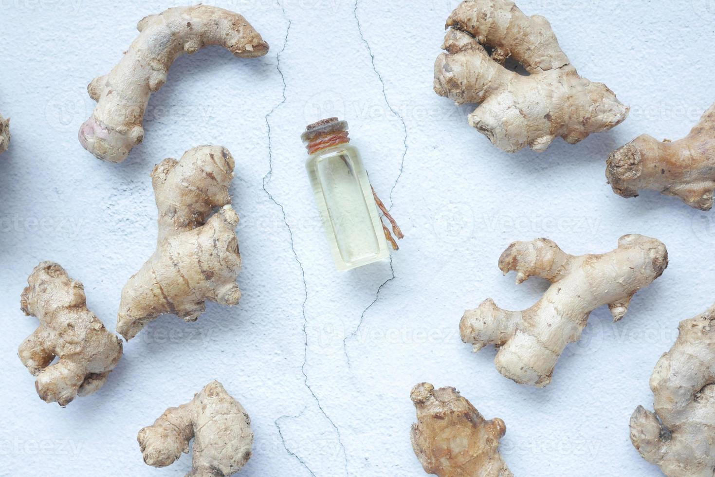 Close up of Gingers and oil in a small container on table photo