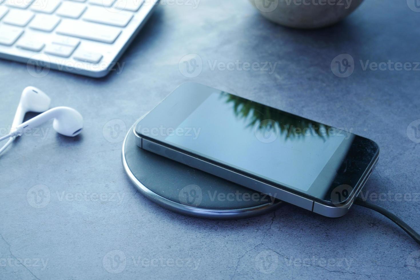 Charging Smartphone using Wireless Charging Pad, top view photo