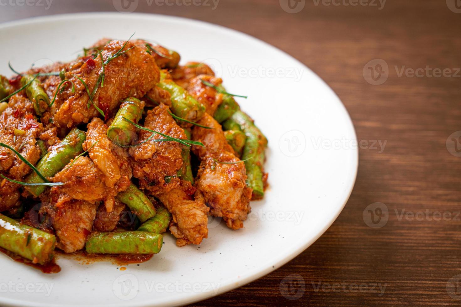 Stir fried pork and red curry paste with sting bean photo