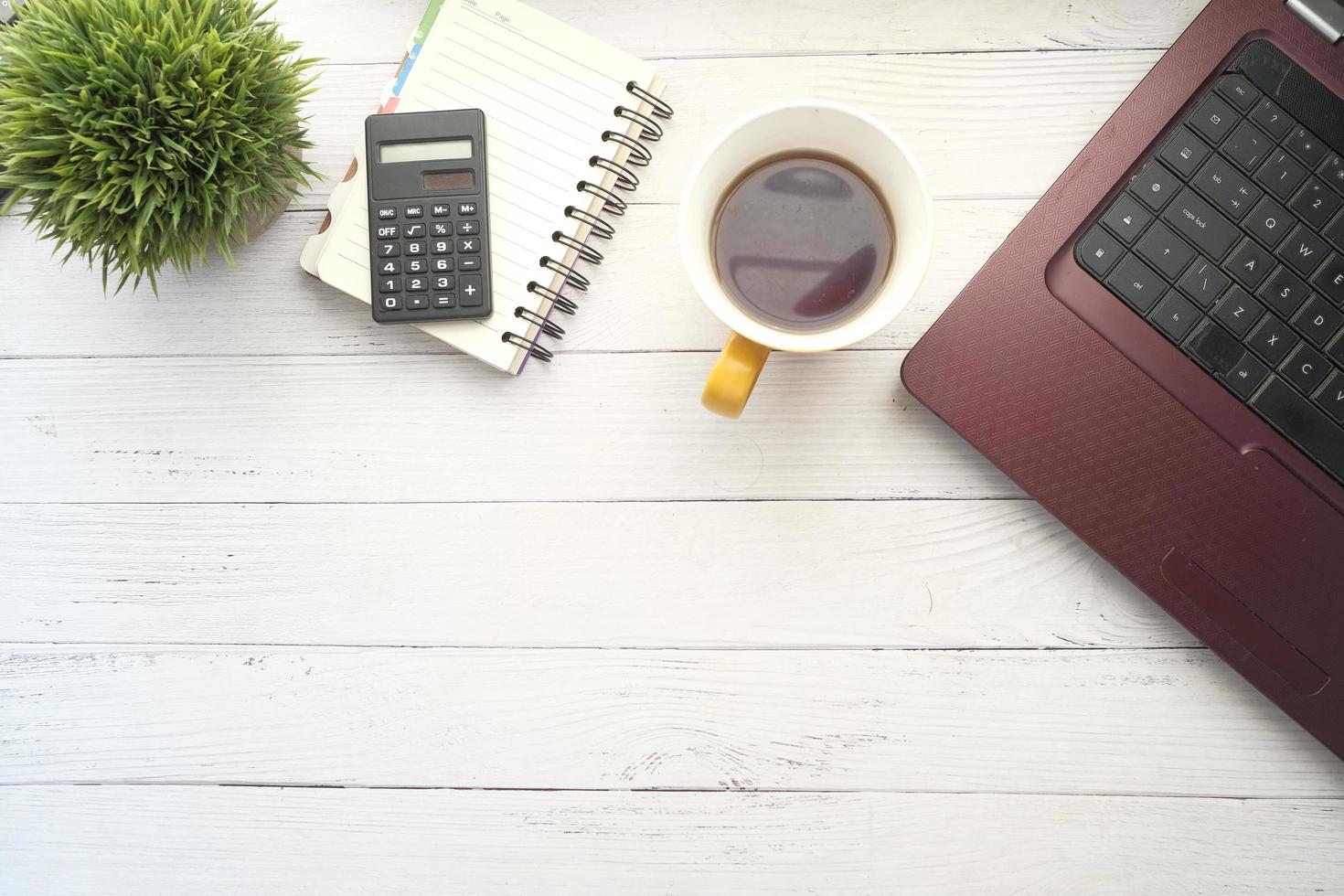 Flat composition of laptop and office stationary on office desk photo