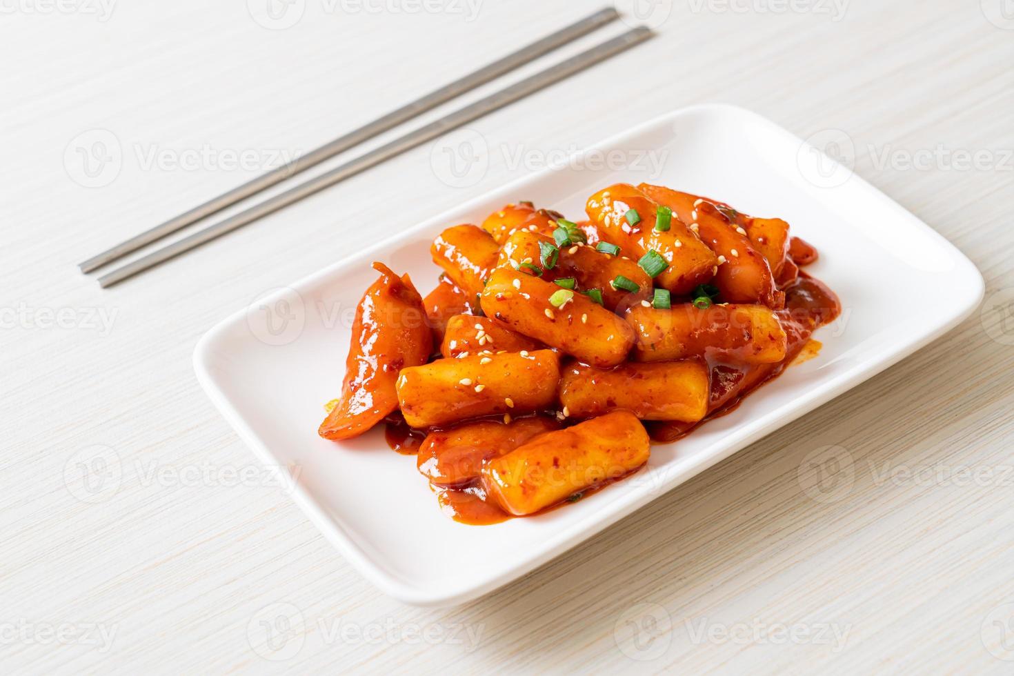 Korean rice cake stick with sausage in spicy sauce - Tteokbokki photo