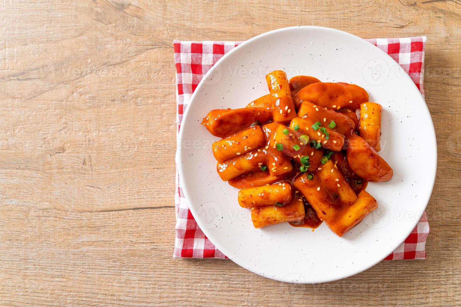 Korean rice cake stick with sausage in spicy sauce - Tteokbokki photo