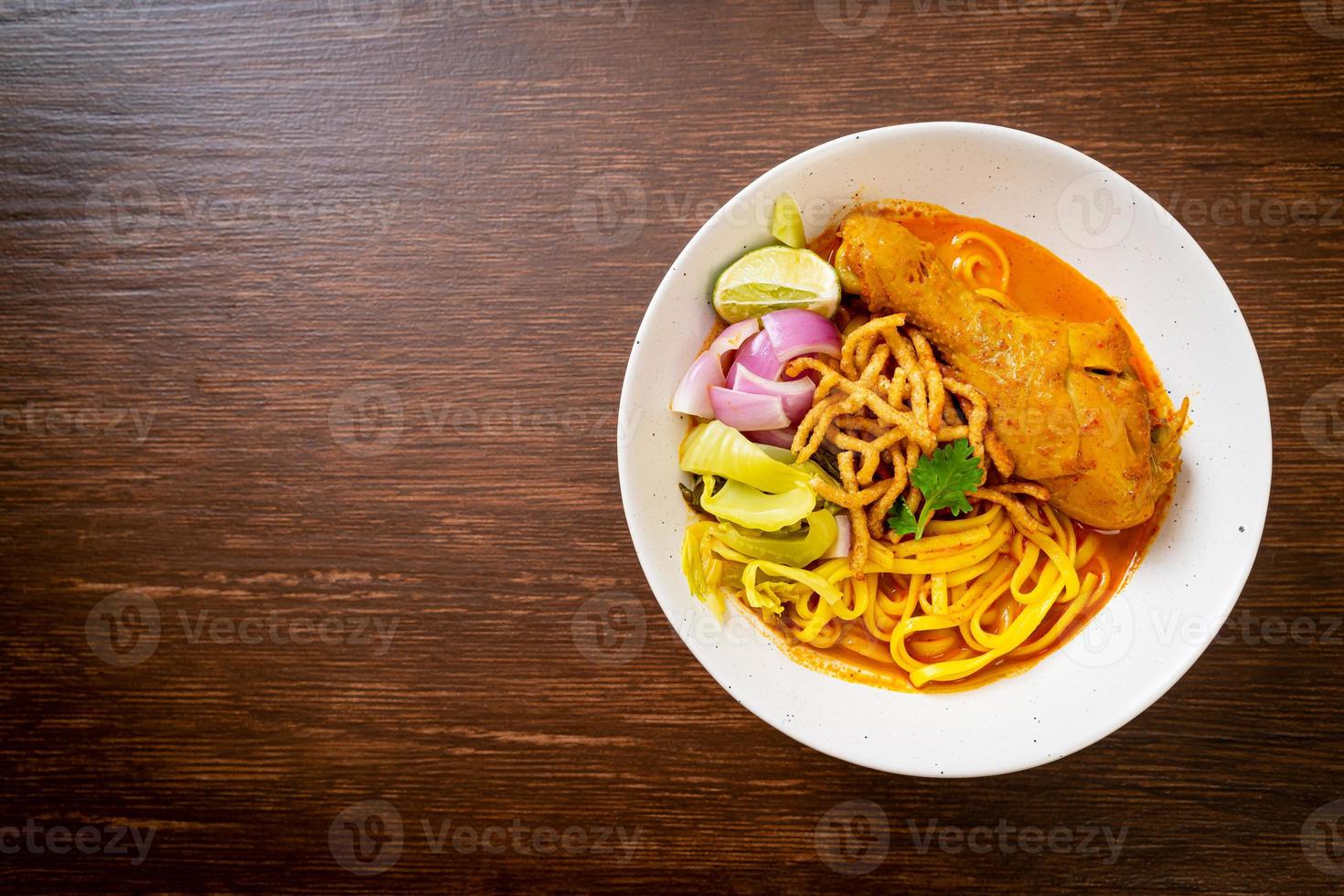 Northern Thai noodle curry soup with chicken photo
