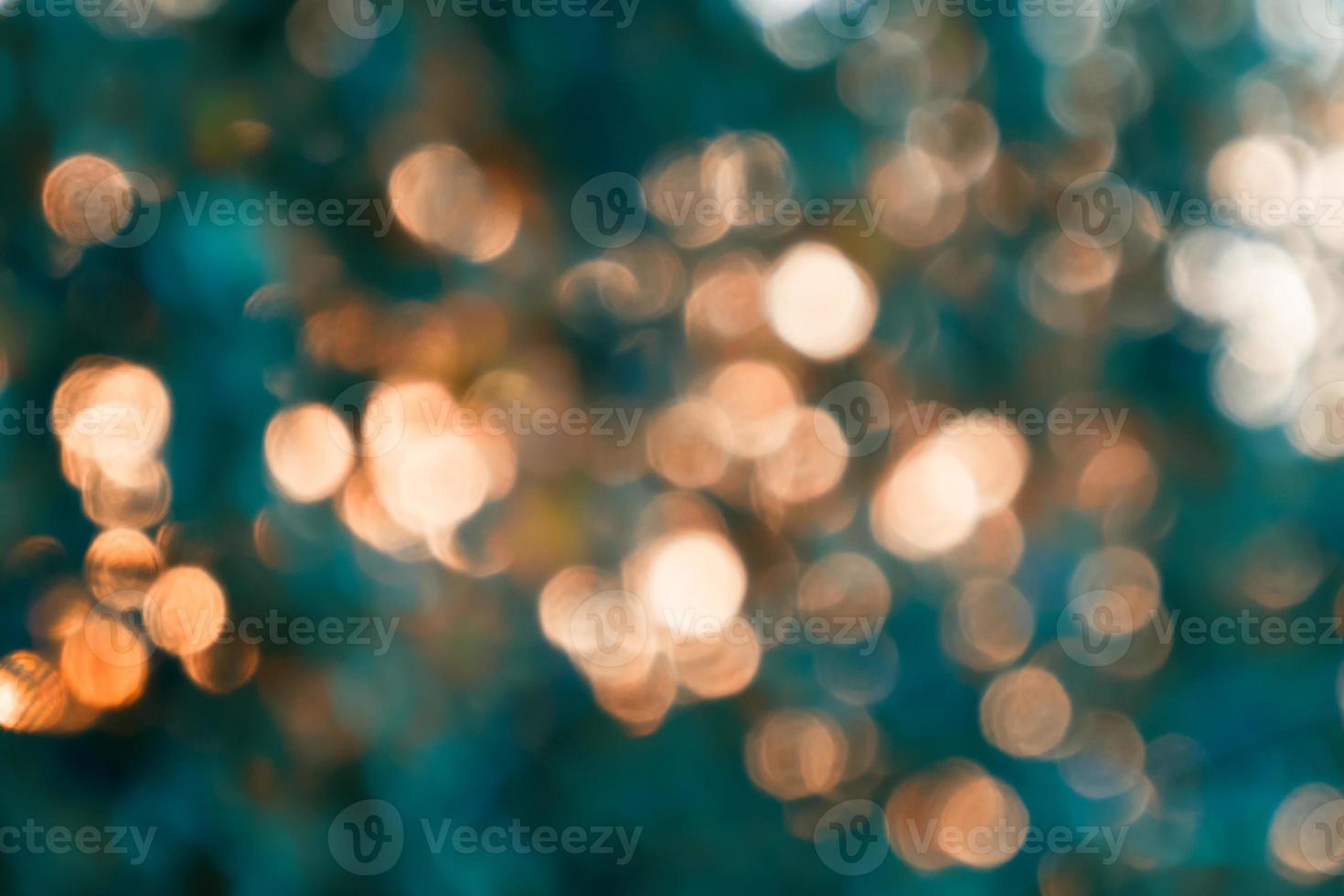 Beautiful colored circles bokeh from the leaves hitting the sunlight. photo