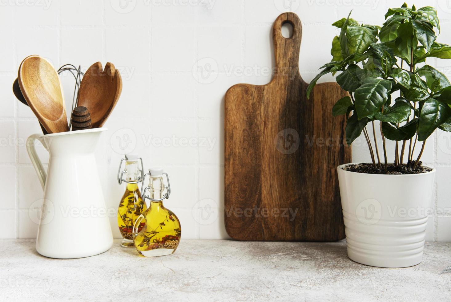 Kitchen utensils, tools and dishware on on the background white tile wall. photo