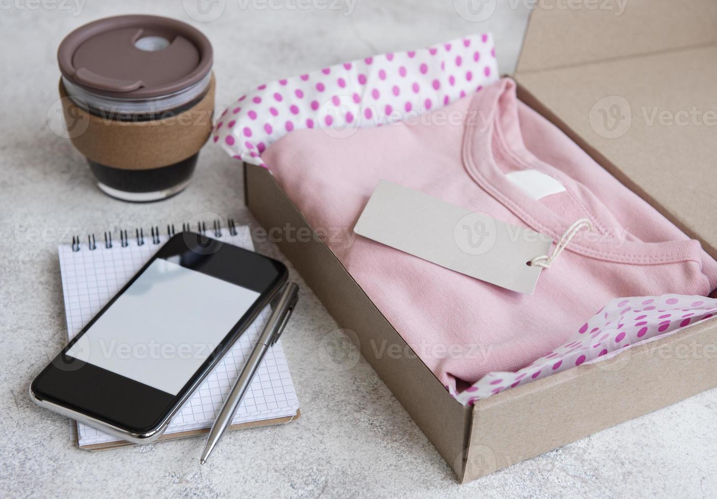 Clothes fir kids in an open cardboard box photo