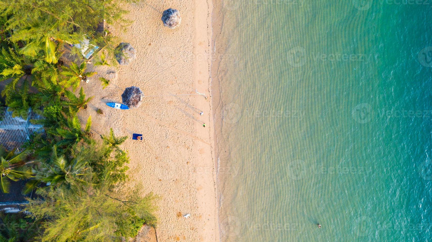 Aerial view of Beach with shade emerald blue water and wave foam on tropical sea photo