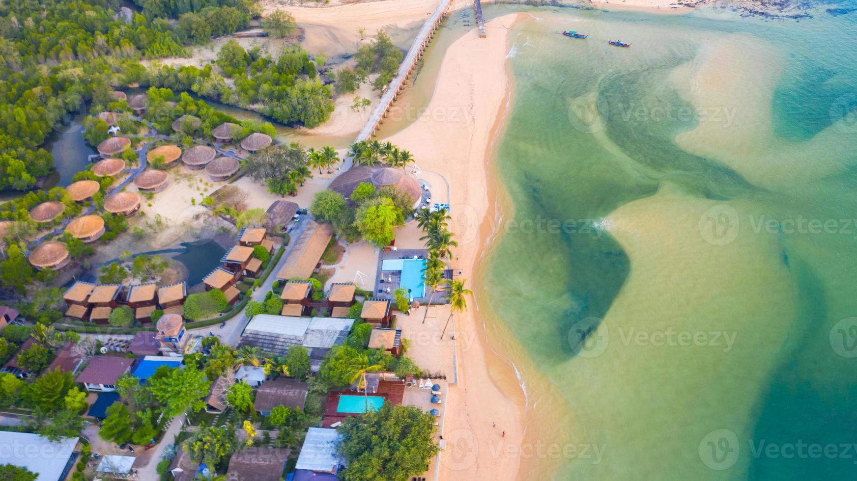 Aerial top view, Resort and beach with emerald blue water on beautiful tropical sea in thailand photo