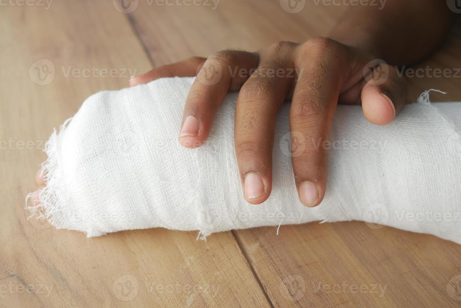 Injured painful hand with bandage photo