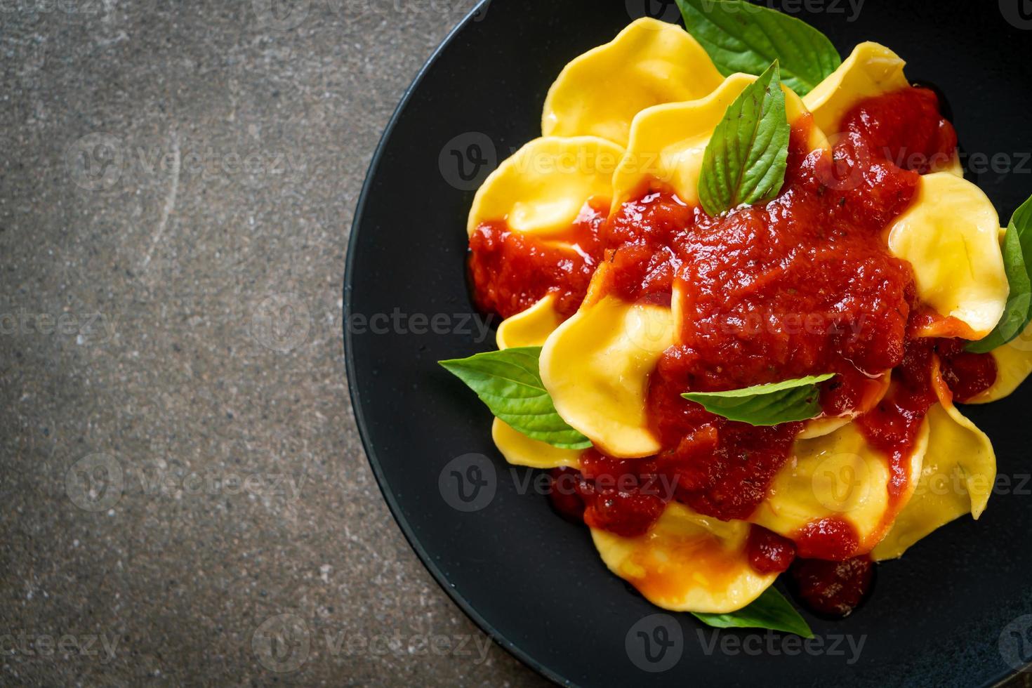 Ravioli with tomato sauce and basil photo