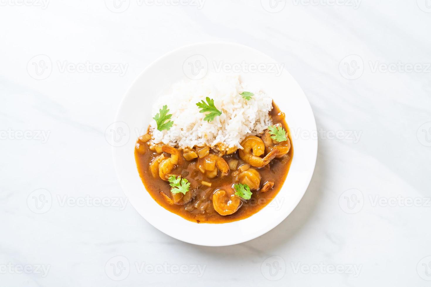 Shrimps in curry sauce on rice photo