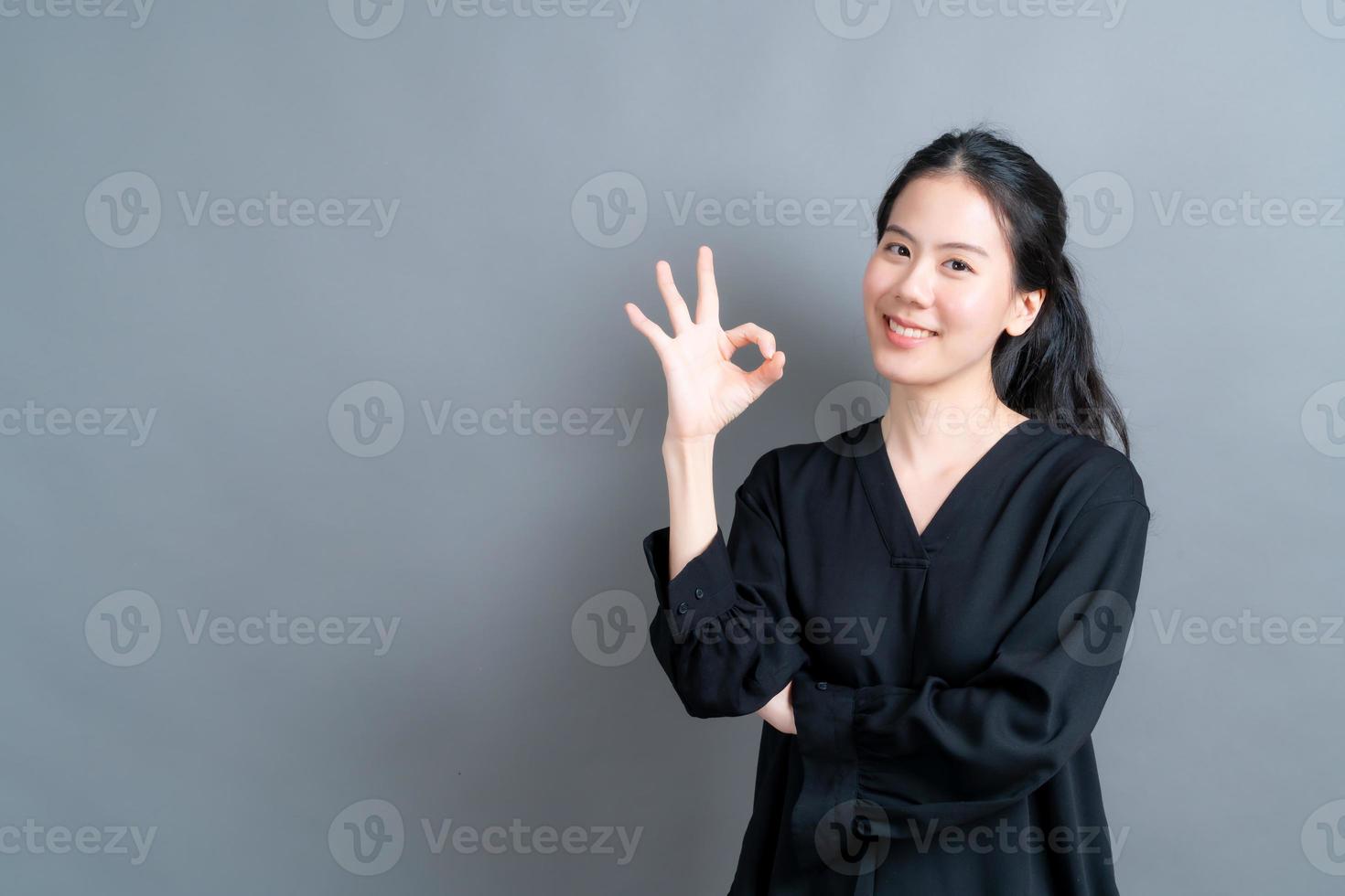 Young Asian woman smiling and showing OK sign photo