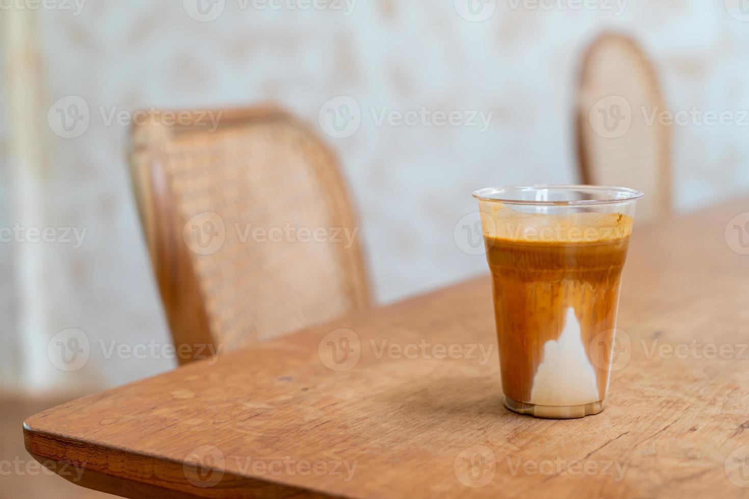 Specialty coffee menu called 'Dirty coffee' . Cold milk in the bottom with hot espresso shot on top photo