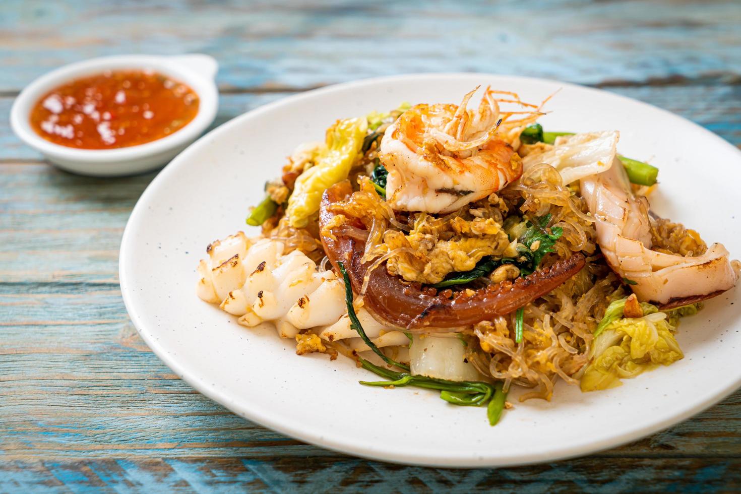 Stir-fried vermicelli with vegetables and seafood  in sukiyaki sauce photo