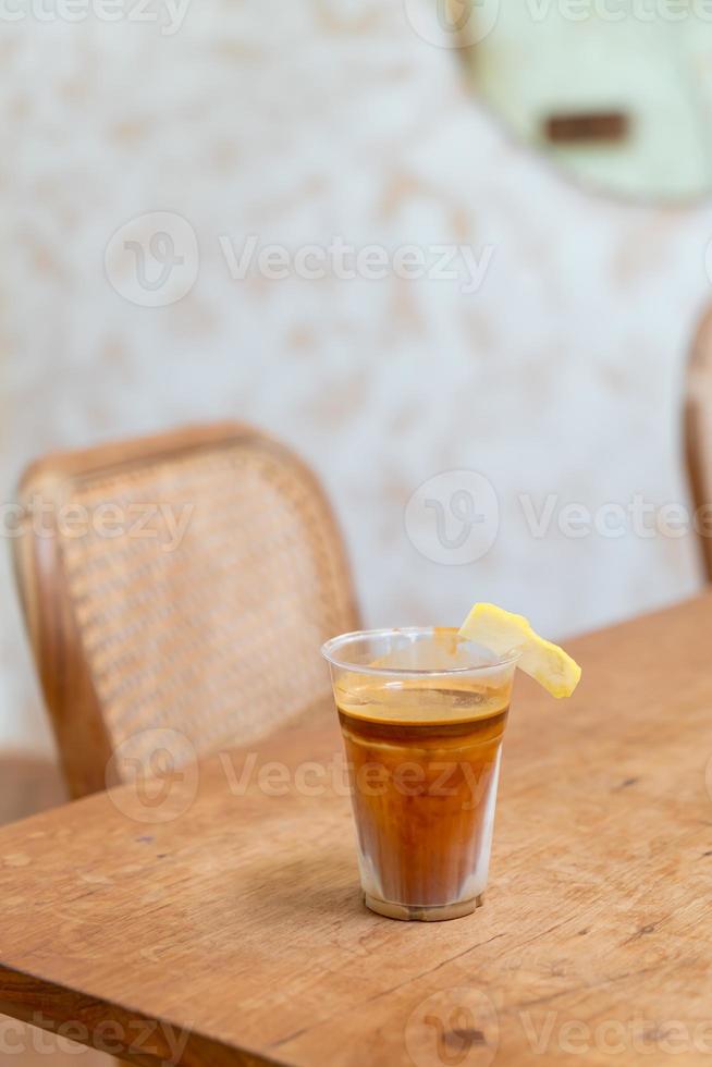 Specialty coffee menu called 'Dirty coffee' . Cold milk in the bottom with hot espresso shot on top photo