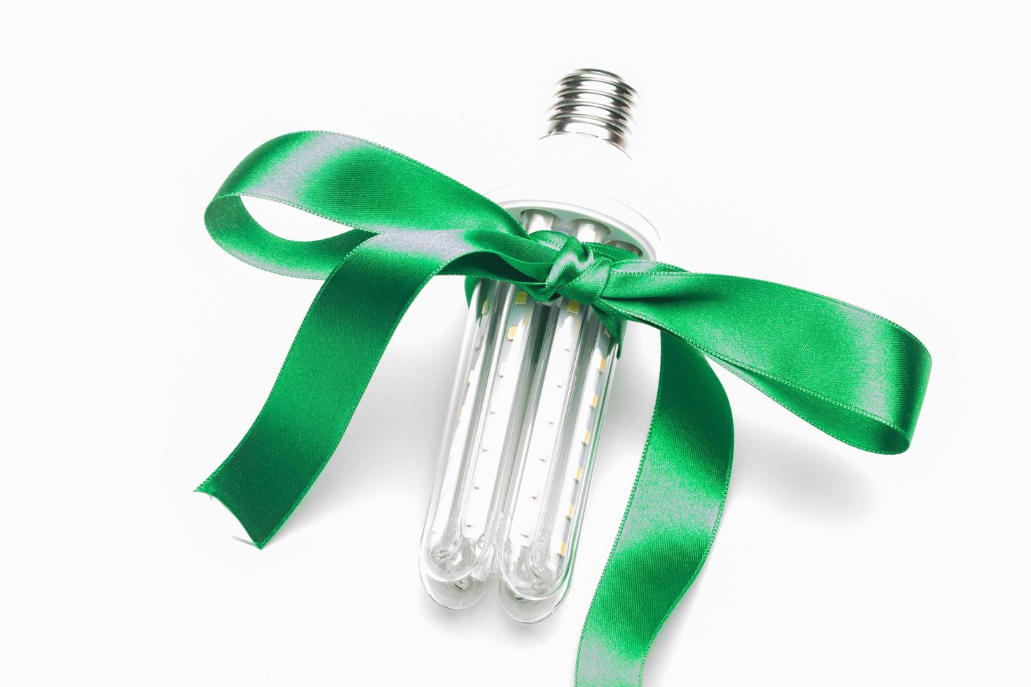 Eco-friendly bulb, decorated with a green ribbon photo