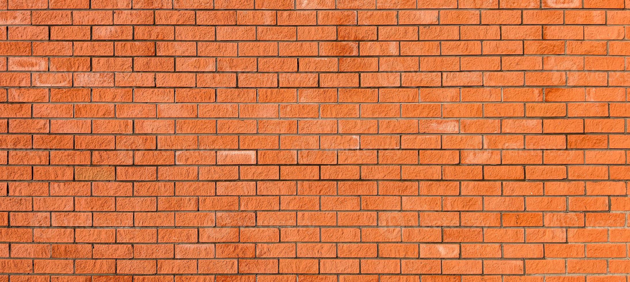 Red new brick wall, wide panorama of masonry. Ideal background for any projects. photo
