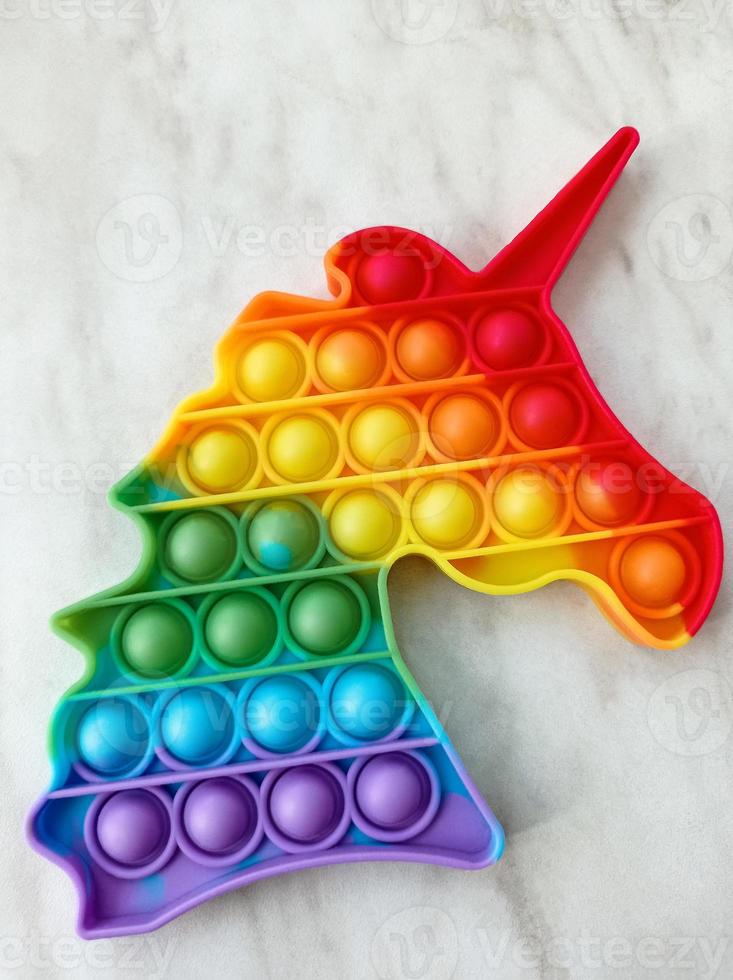 Rainbow toy for children in the shape of a unicorn head photo