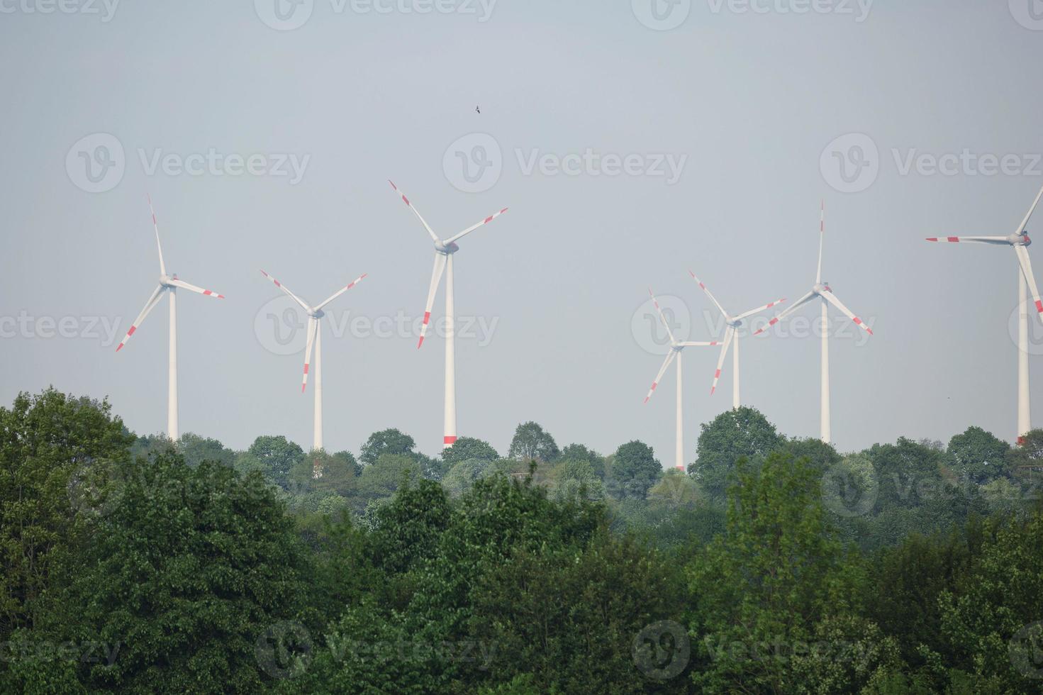 Windmills, power plant and turbines near Kiel canal in Germany photo