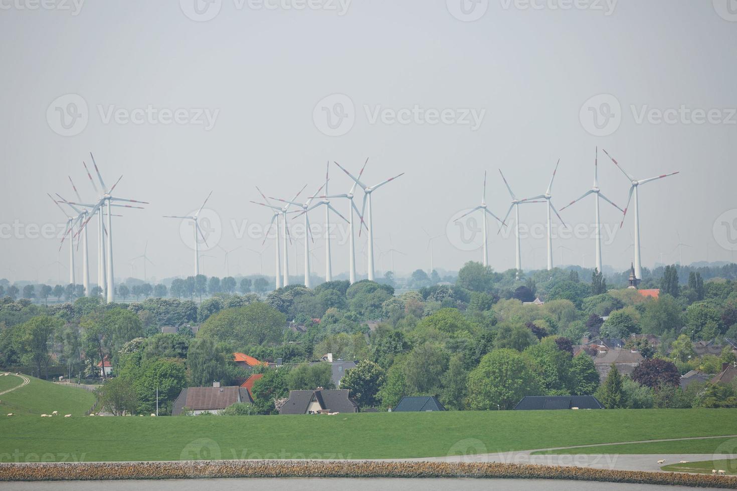 Windmills, power plant and turbines near Kiel canal in Germany photo