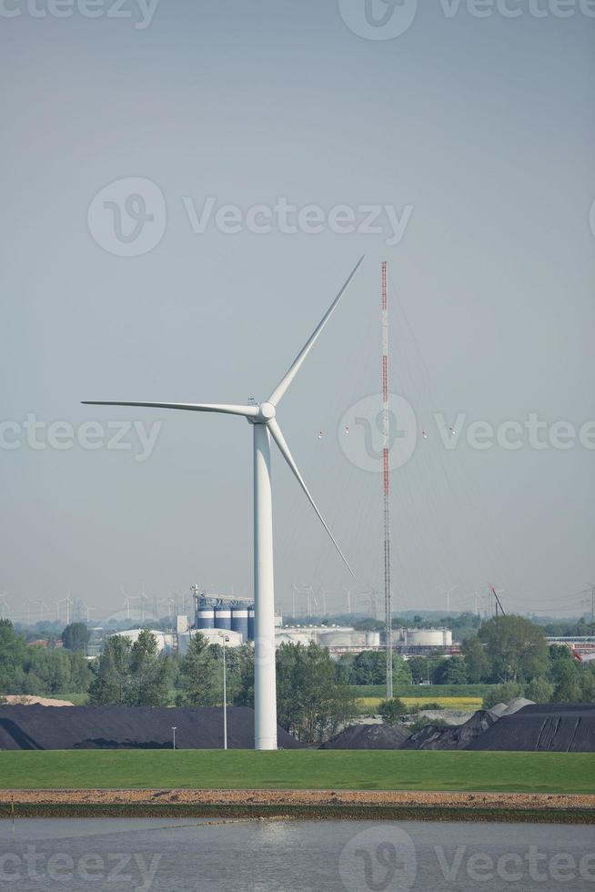 Windmills, power plant and turbines near Kiel canal in Germany photo