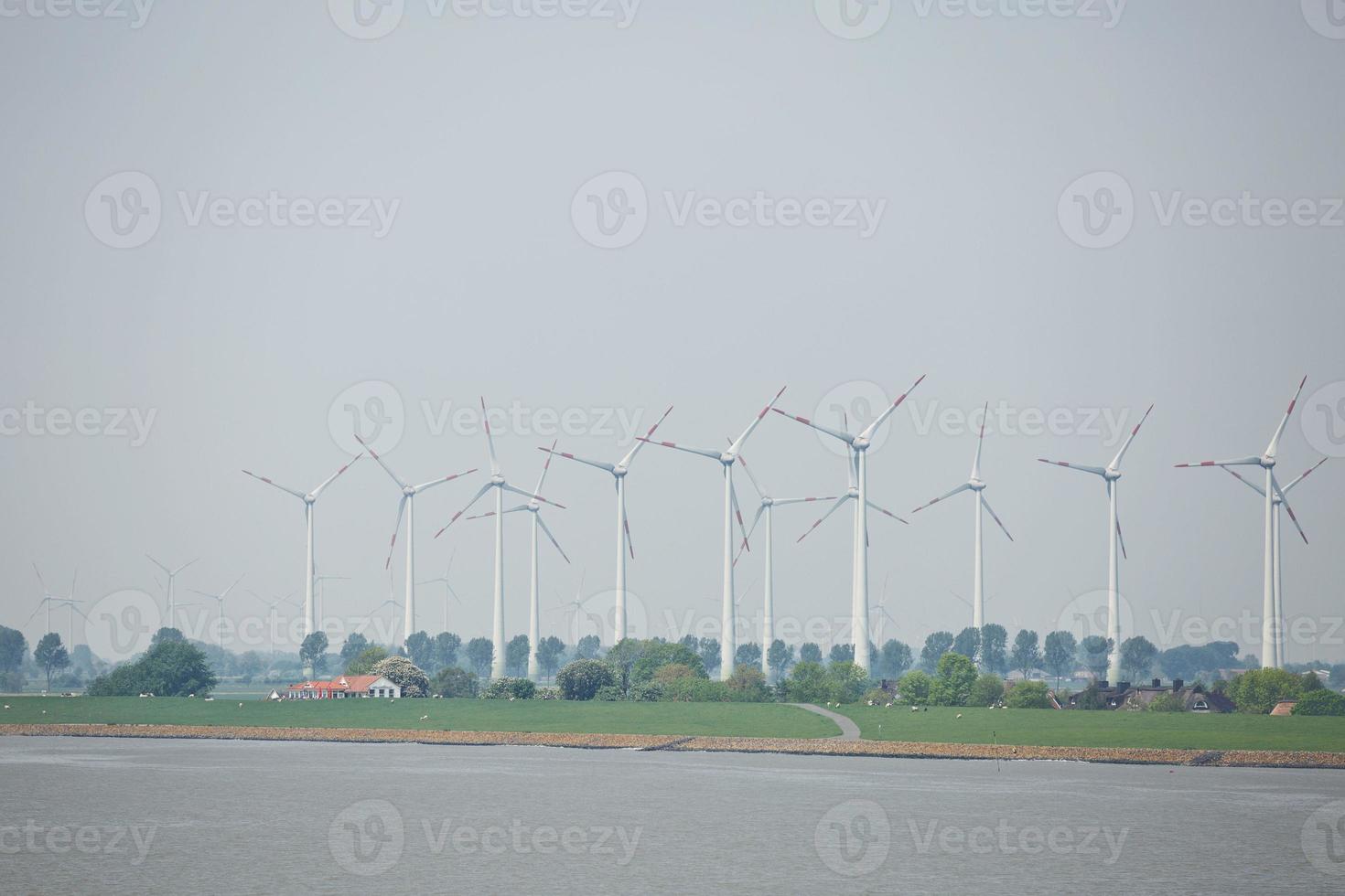 Windmills, power plant and turbines near Kiel canal in Germany photo