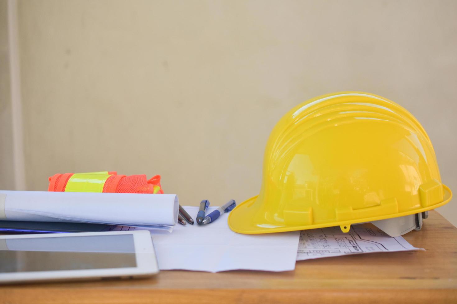 Seguridad de casco amarillo para ingeniería en el escritorio en la oficina foto