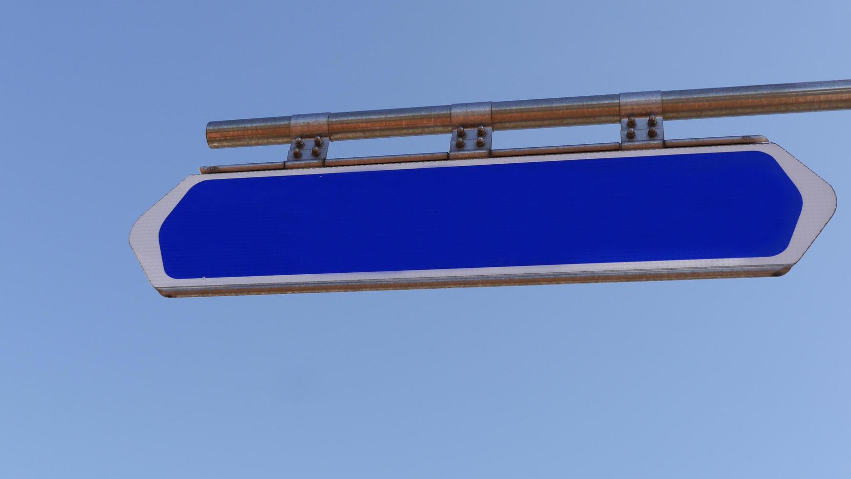 Template. Blue road sign with empty space and sky on a background photo