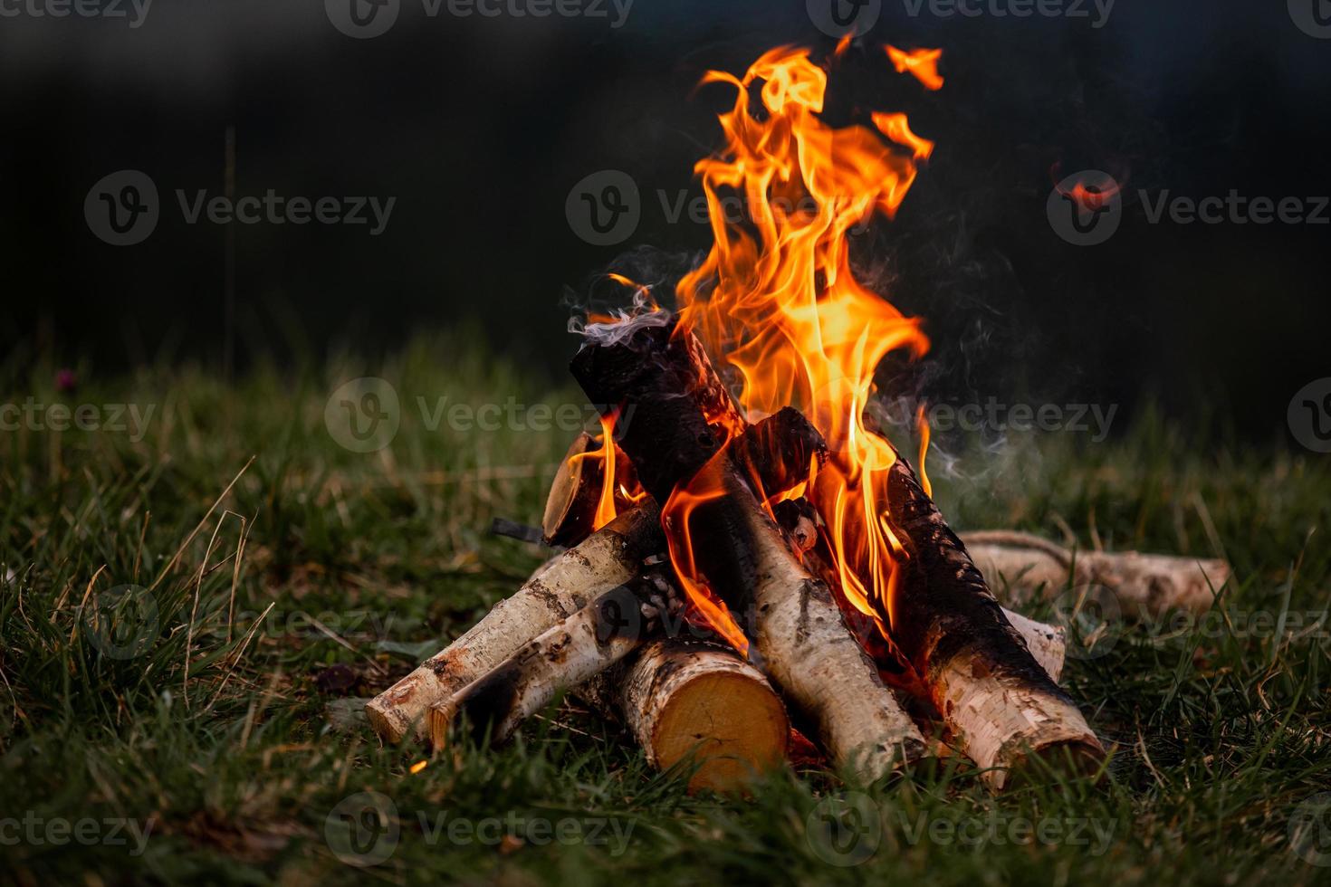 Burning bonfire in the evening in the Carpathian mountains. Place for inscription photo