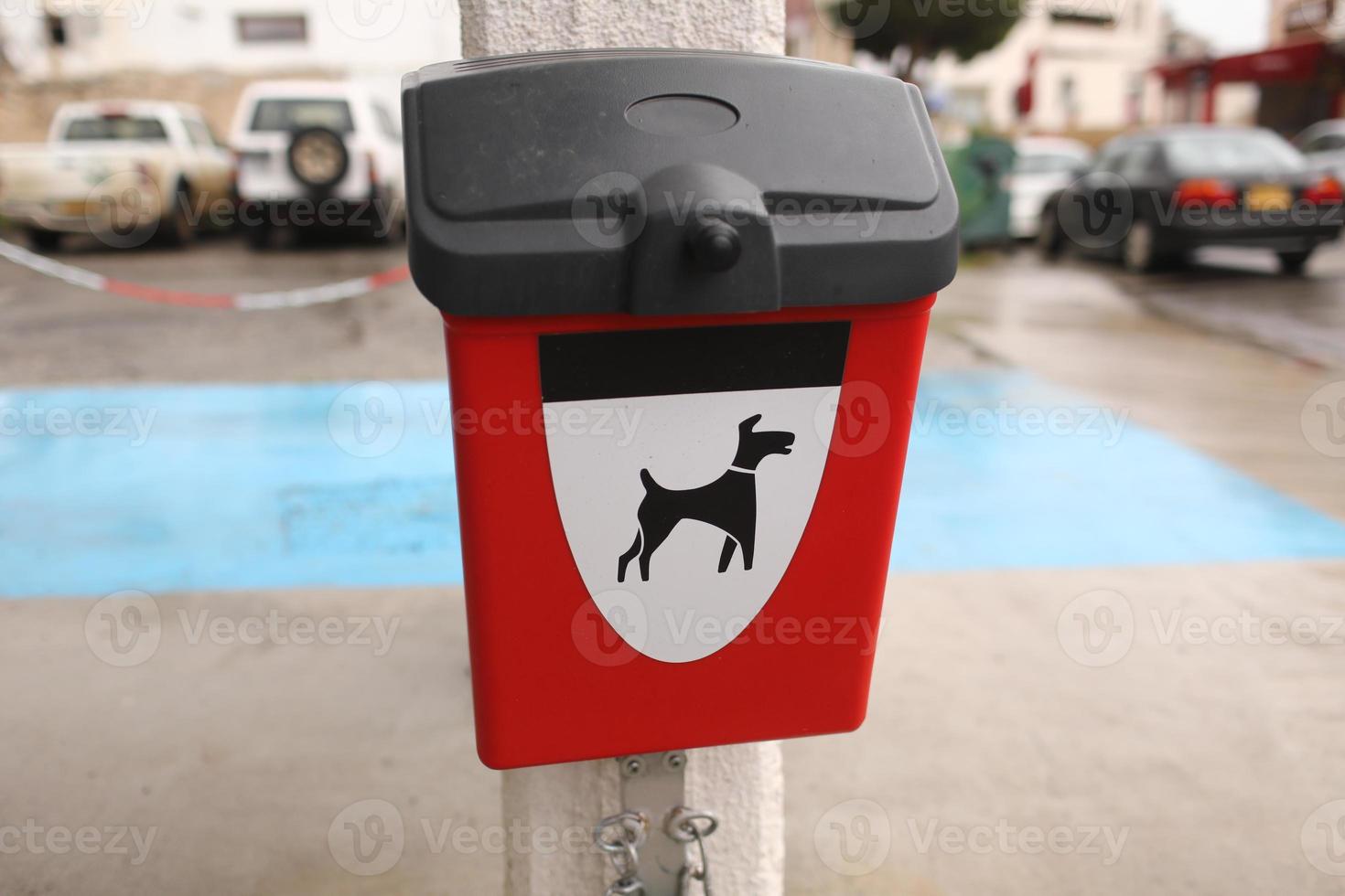 Red box with packages for dogs poop outdoors photo