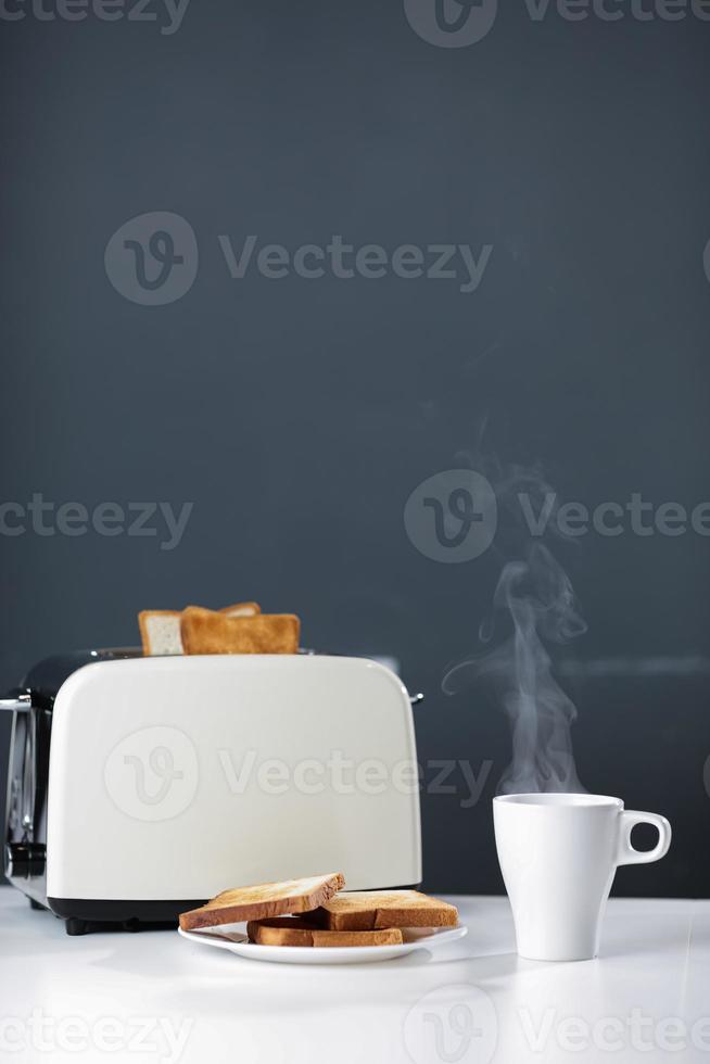 Toaster with hot steaming coffee for breakfast photo