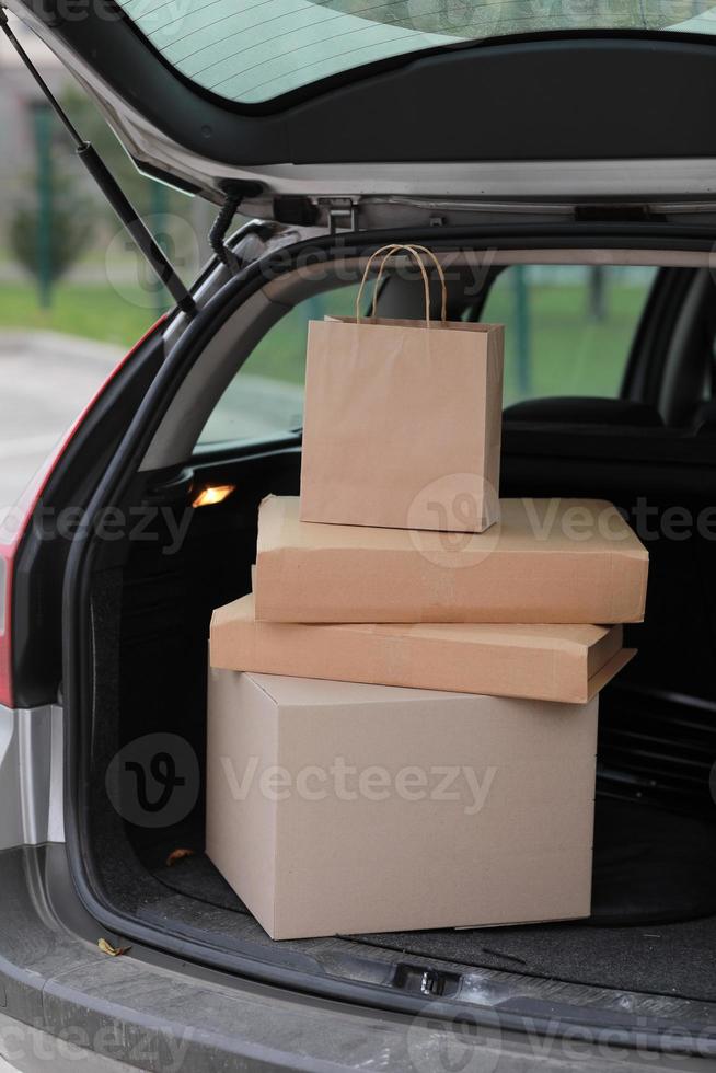 Parcels in boxes in the car outdoors photo