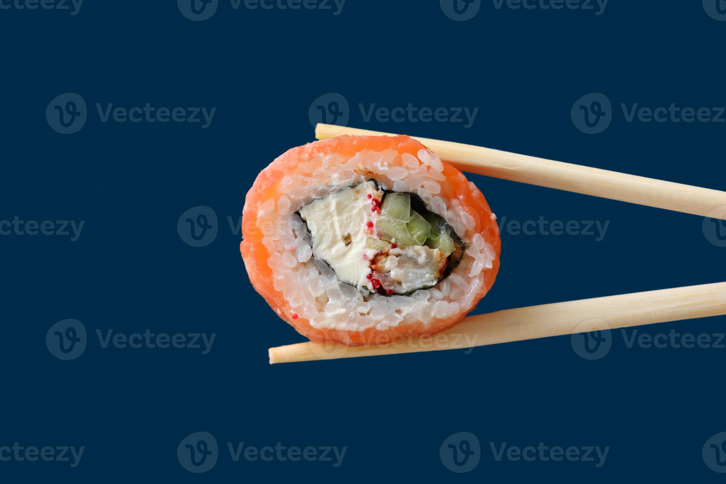 Close Up Fresh Salmon Sushi Roll With Wooden Chopsticks 2727566 Stock Photo At Vecteezy