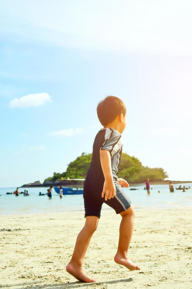 chicos corriendo en la playa foto