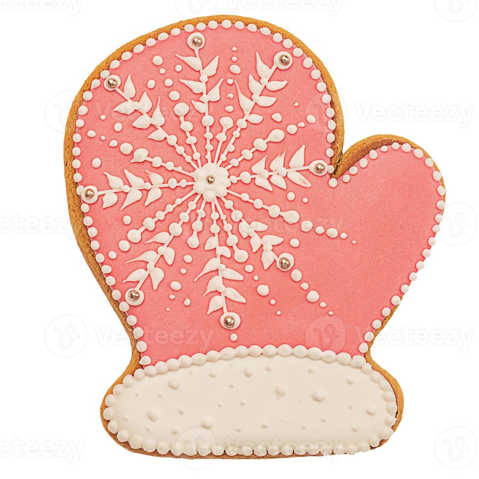 año Nuevo. manopla de galleta de jengibre rosa sobre fondo blanco. manopla de pan de jengibre rosa navideña. foto